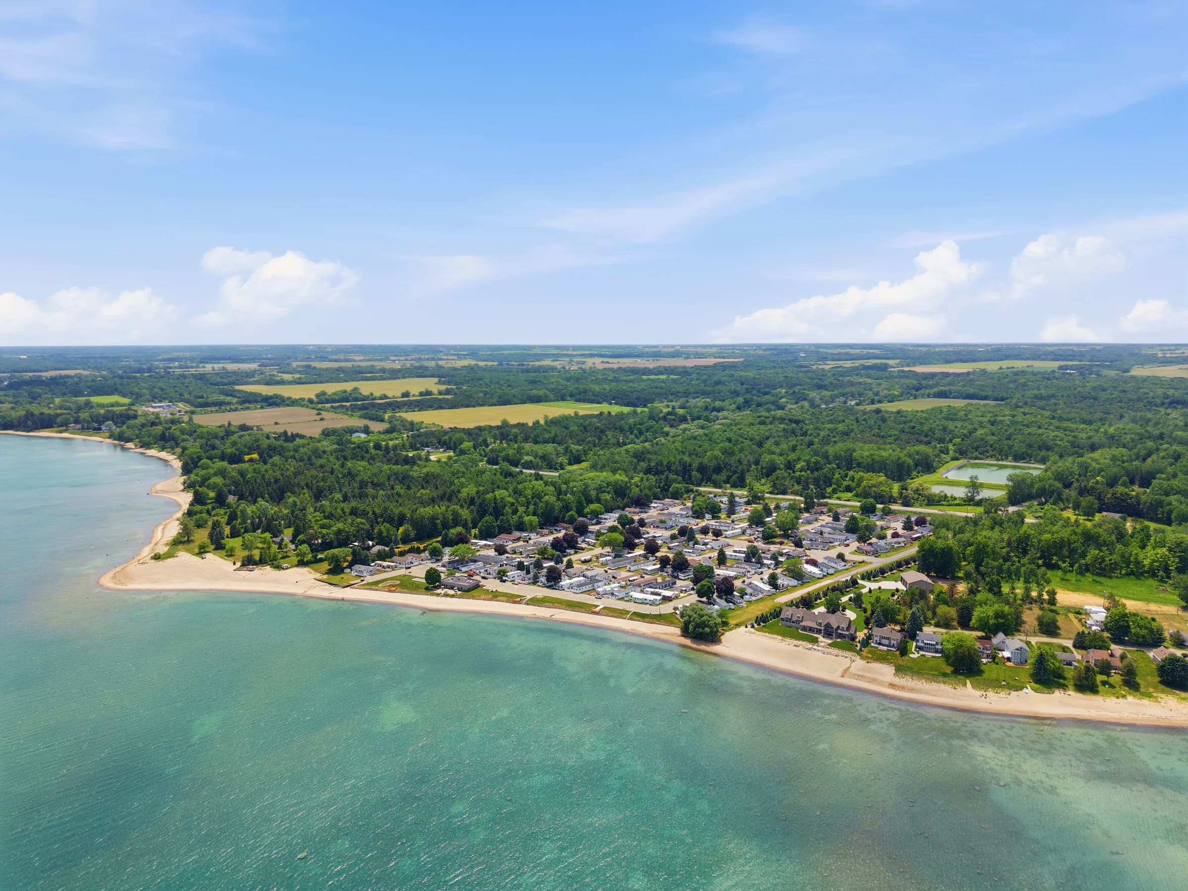 Sweeping aerial view along the Lake Huron shoreline at Huron Shores