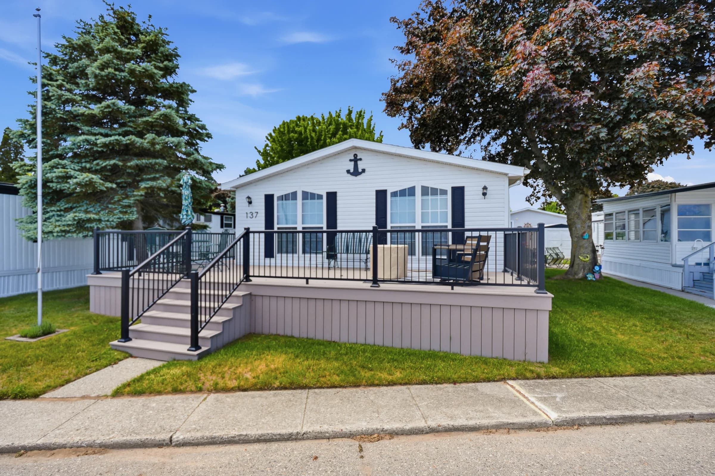 Manufactured home with a large front deck at Huron Shores