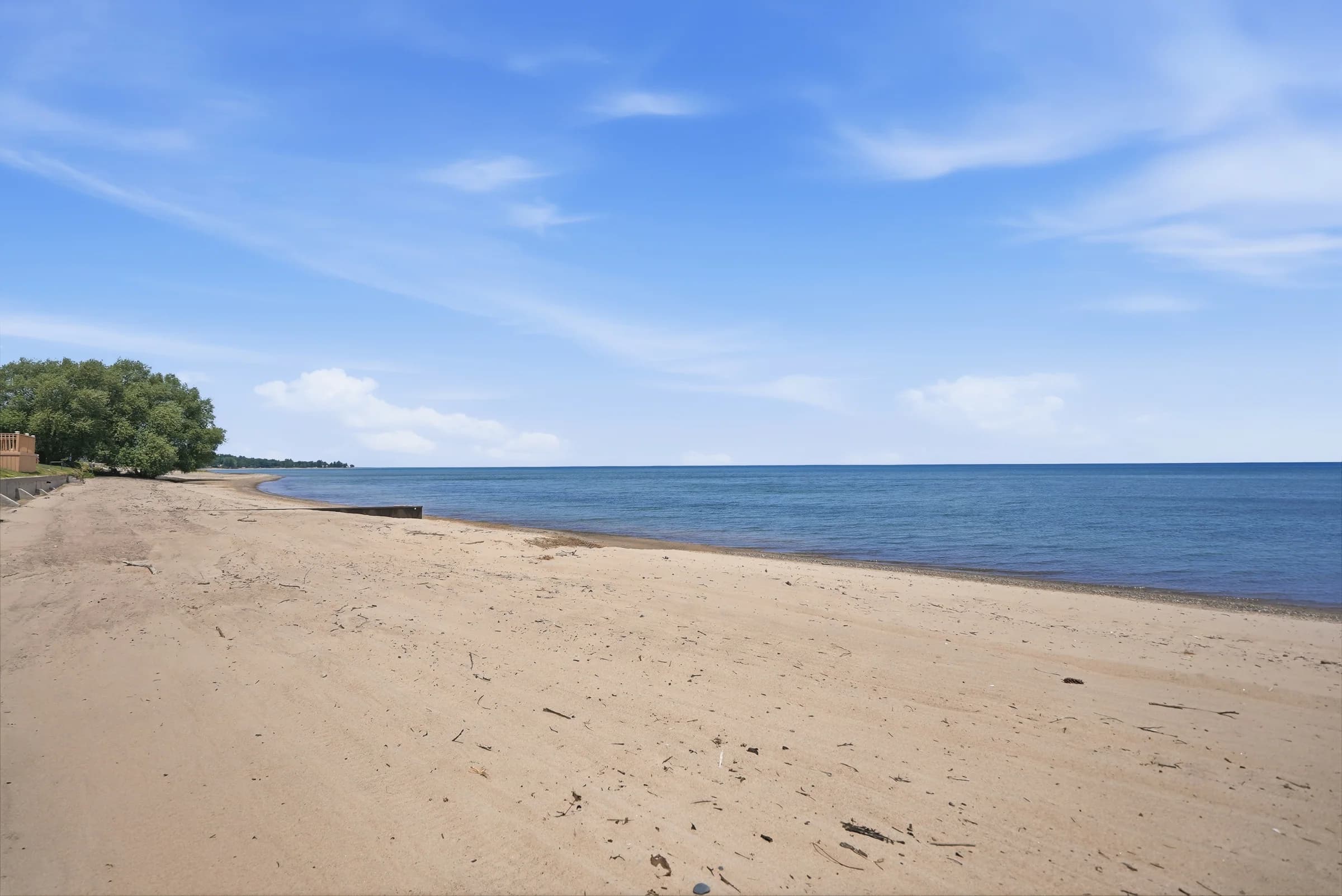 Wide view of the private sandy beach at Huron Shores